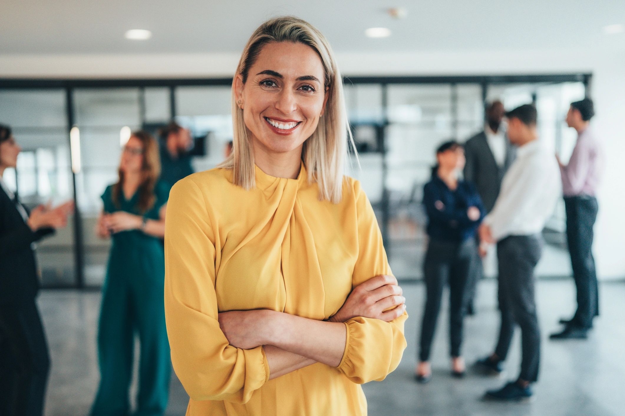 Professional coach standing confidently in a modern office